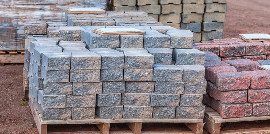 Stacks of various colored concrete pavers (paving stone) or pati